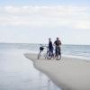 Couple with bike on Fanø beach