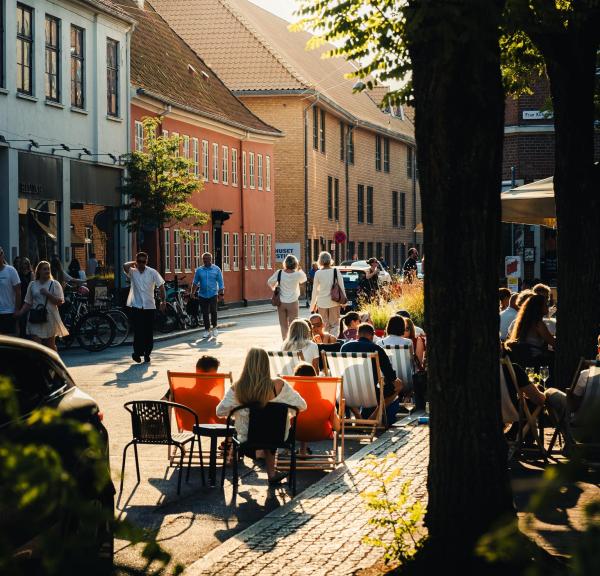 People sitting outside in Vestergade in Aarhus during summer