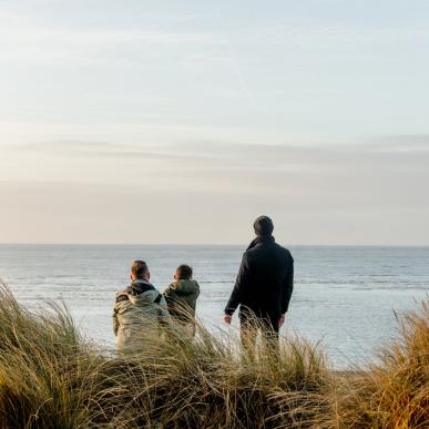 Family watching the sea on Blåvand beach in West Jutland