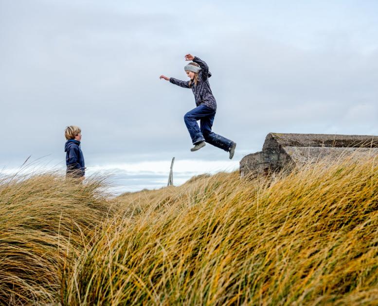 Kids plating in the sand dunes on Klitmøller, Jutland
